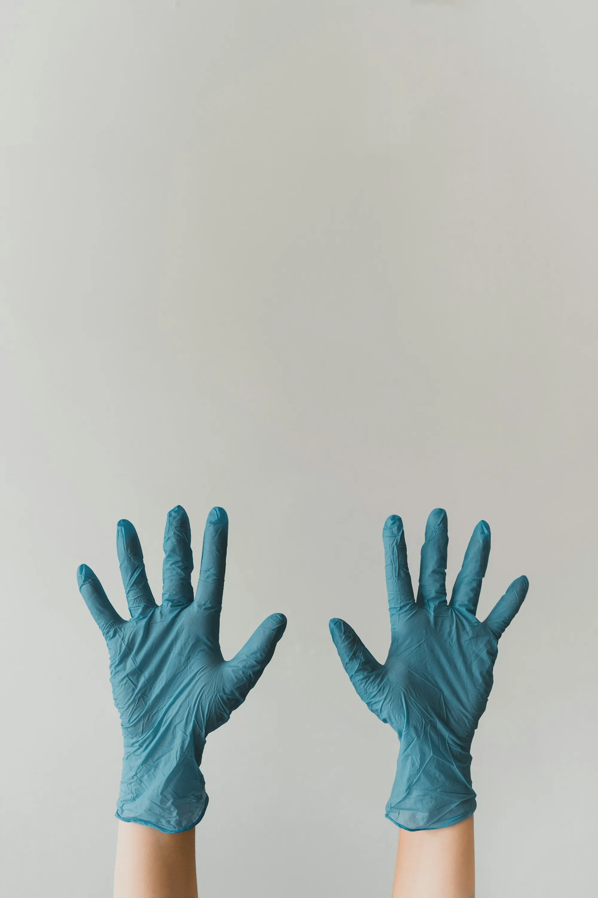 Pair of hands in blue nitrile gloves